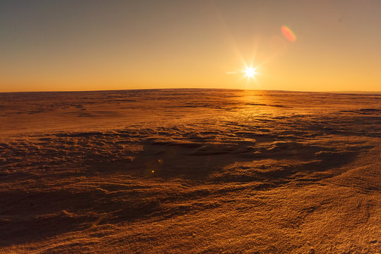 Martian sunset (Mars planet) red landscape. Looks like cold desert on Mars. A huge field of ice