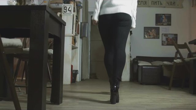 Bottom view of the fact the girl goes to the cafe in slow-motion