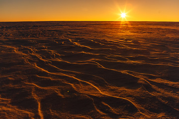 Martian sunset (Mars planet) red landscape. Looks like cold desert on Mars. A huge field of ice