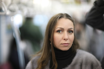 Portrait of a woman during a trip to Tokyo subway train