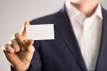 businessman holding blank visit card