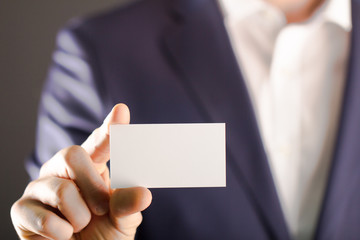 businessman holding blank visit card