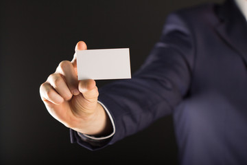 businessman holding blank visit card