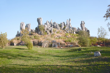 Fototapeta na wymiar White grey colored tall standing rocks on a hill, China.