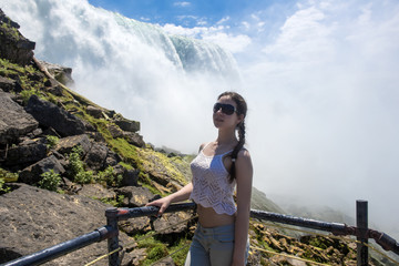 Teenage girl on the background of Niagara Falls