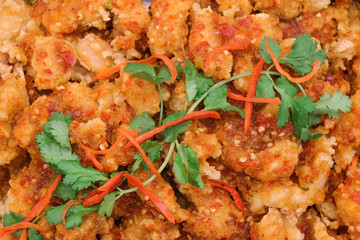 Closeup shot of deep fried chicken with chilli sauce.  