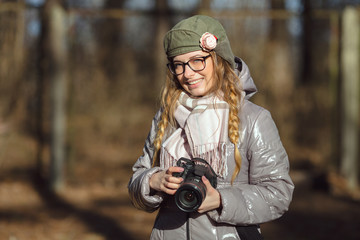 Fototapeta premium Young european woman photographer enjoying first spring sun exploring suburban locations