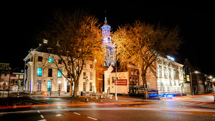 KAMPEN, NETHERLANDS - December 10, 2016: Beautifully featured city with beautiful monuments and towers. Photo taken during night photography with long exposure, Kampen, Overijssel - Netherlands.  - obrazy, fototapety, plakaty