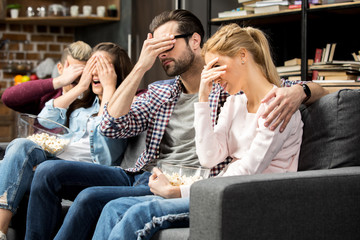 Friends covering their eyes