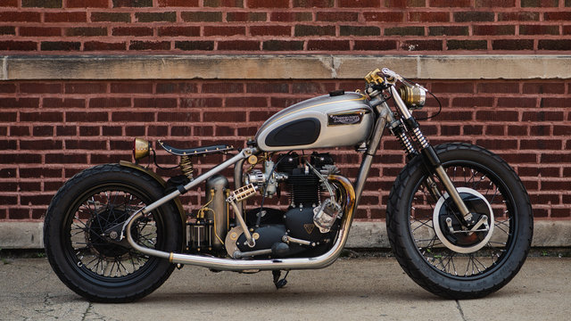 old motorcycle against brick wall