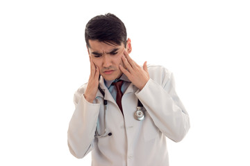 a young doctor in a white lab coat keeps head