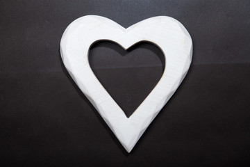 Holidays gift and heart on a black background. Valentines day