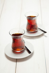 Two cups of tea on a white wooden background
