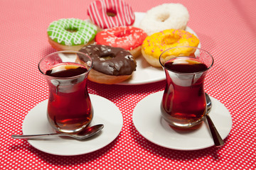 Two cups of tea on a red table