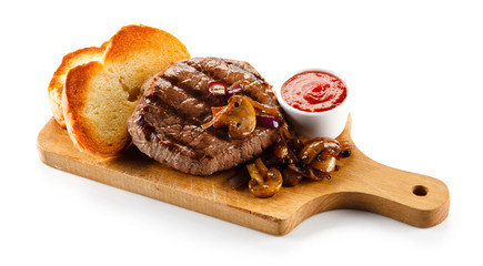 Grilled steak and toasts on wooden board