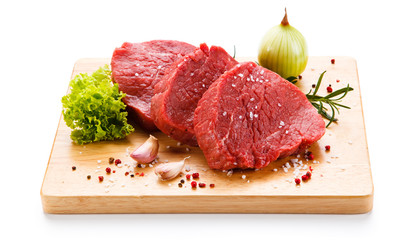 Fresh raw steaks on wooden desk