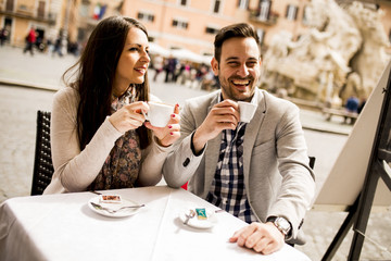 Loving couple drinking coffee in Rome, Italy