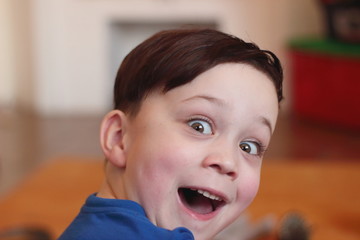 Expressive happy surprised boy. Turned around and saw the long-awaited surprise.