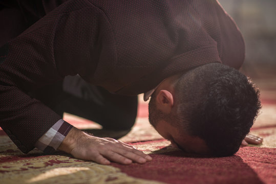 Muslim prostrating on the ground