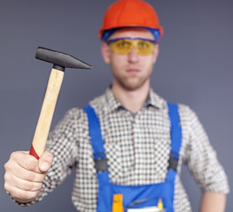 Hammer  and serios  blurred  figure  of worker in uniform