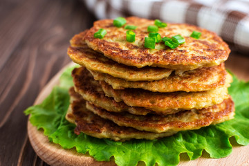 Fried potato pancakes on wooden background