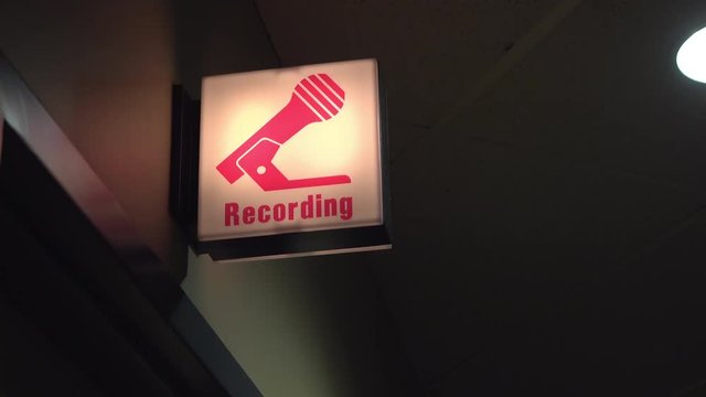 Recording light blinking outside of studio at radio station.
