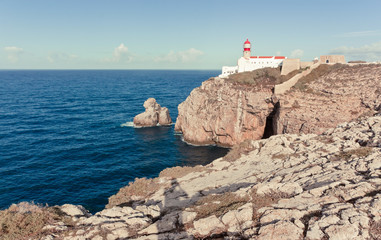 Fototapeta na wymiar Beacon at Cape St. Vincent, the southwesternmost point of Portugal and of mainland Europe. Edge of the earth. Rocks and the Atlantic ocean. Famous viewpoint in Portugal.