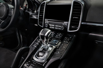 Black luxury car Interior - shift lever and dashboard