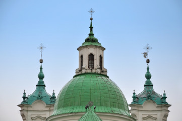 Fototapeta na wymiar Dome and towers of the Jesuit church in Baroque style on a background of blue sky. Grodno, Belarus.