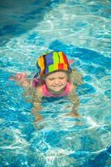 Cute little child swimming in pool