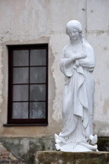 Fototapeta na wymiar White statue of the Blessed Virgin Mary. Slonim, Grodno region, Belarus.