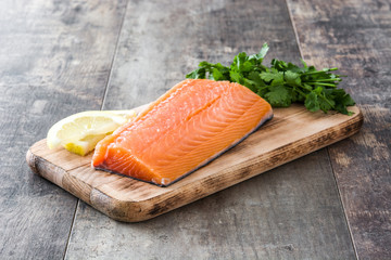 Raw salmon fillet on wooden background
