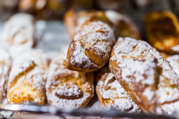 Small cheese danishes in powdered sugar macro closeup