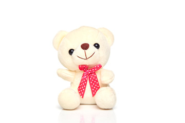 White teddy bear with a red butterfly isolated on a white background
