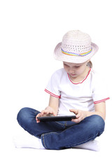 little girl playing on tablet against white background