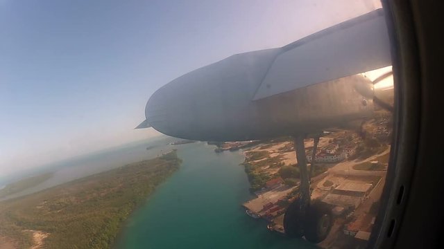 Propeller airplane flying at sunny day
