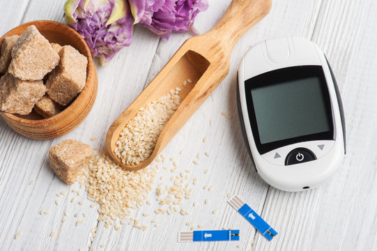 glucose meter, seeds of sesam and brown sugar