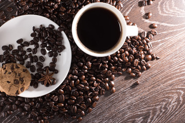 Coffee cup on coffee beans with cookie