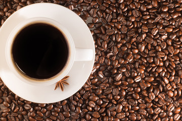 Coffee cup on coffee beans