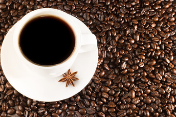 Coffee cup on coffee beans