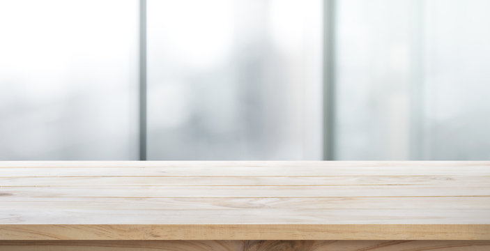 Empty wood table with blur room office and window city view background.For montage product display or key visual layout.