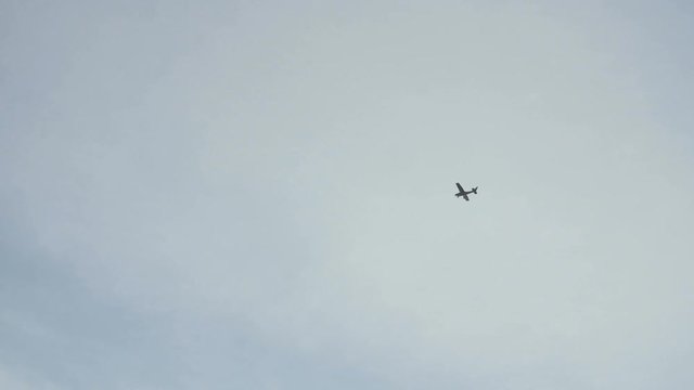 Small airplane is flying,high in the sky, slow motion.