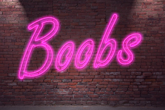 Leuchtreklame Boobs an Ziegelsteinmauer