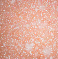 Snowfall over red background daytime