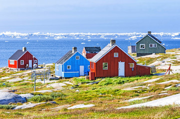 The colorful houses of Rodebay, Greenland. This settlement is located on a small peninsula jutting off the mainland into eastern Disko Bay, 22.5 km north of Ilulissat. It had 46 inhabitants in 2010 - obrazy, fototapety, plakaty