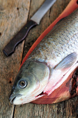 Fresh raw shelled carp with onions, carrots, parsley, salt and pepper.