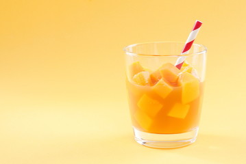 cubes of mango pulp isolated on a yellow background