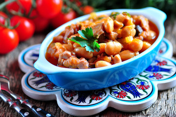 Braised chicken with beans, onions and celery in tomato sauce.