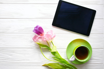 tea cup , tablet and tulips.  Women's day, Mother's Day.