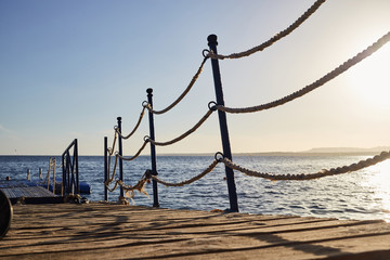 Fototapeta premium pontoon with rope barriers in the sea